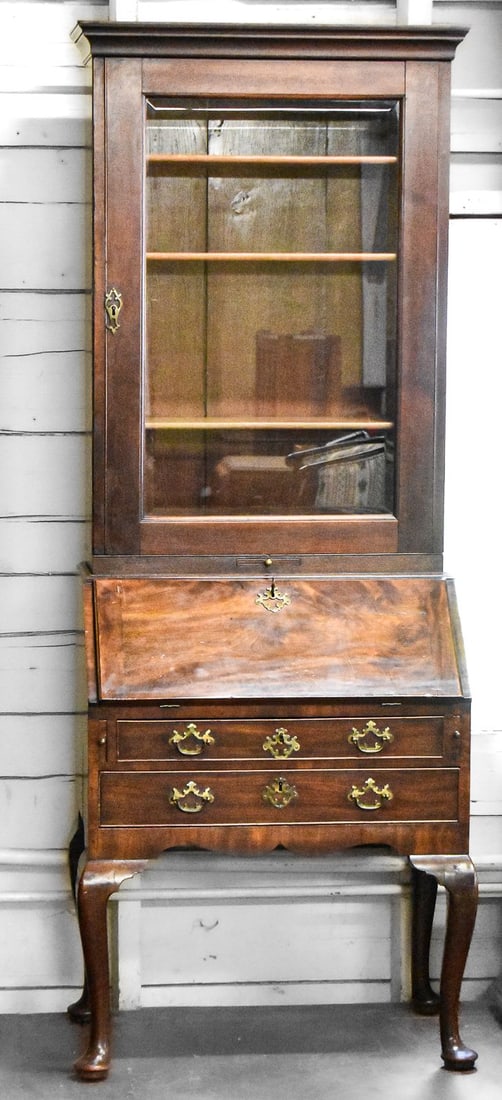 GEORGE II MAHOGANY SECRETAIRE BOOKCASE, CIRCA LATE 18TH CENTURY: A George II mahogany secretaire bookcase with a locking top bookcase, locking drop front secretary desk, and two locking bottom drawers, circa mid 18th century. The top glass front cabinet has three w