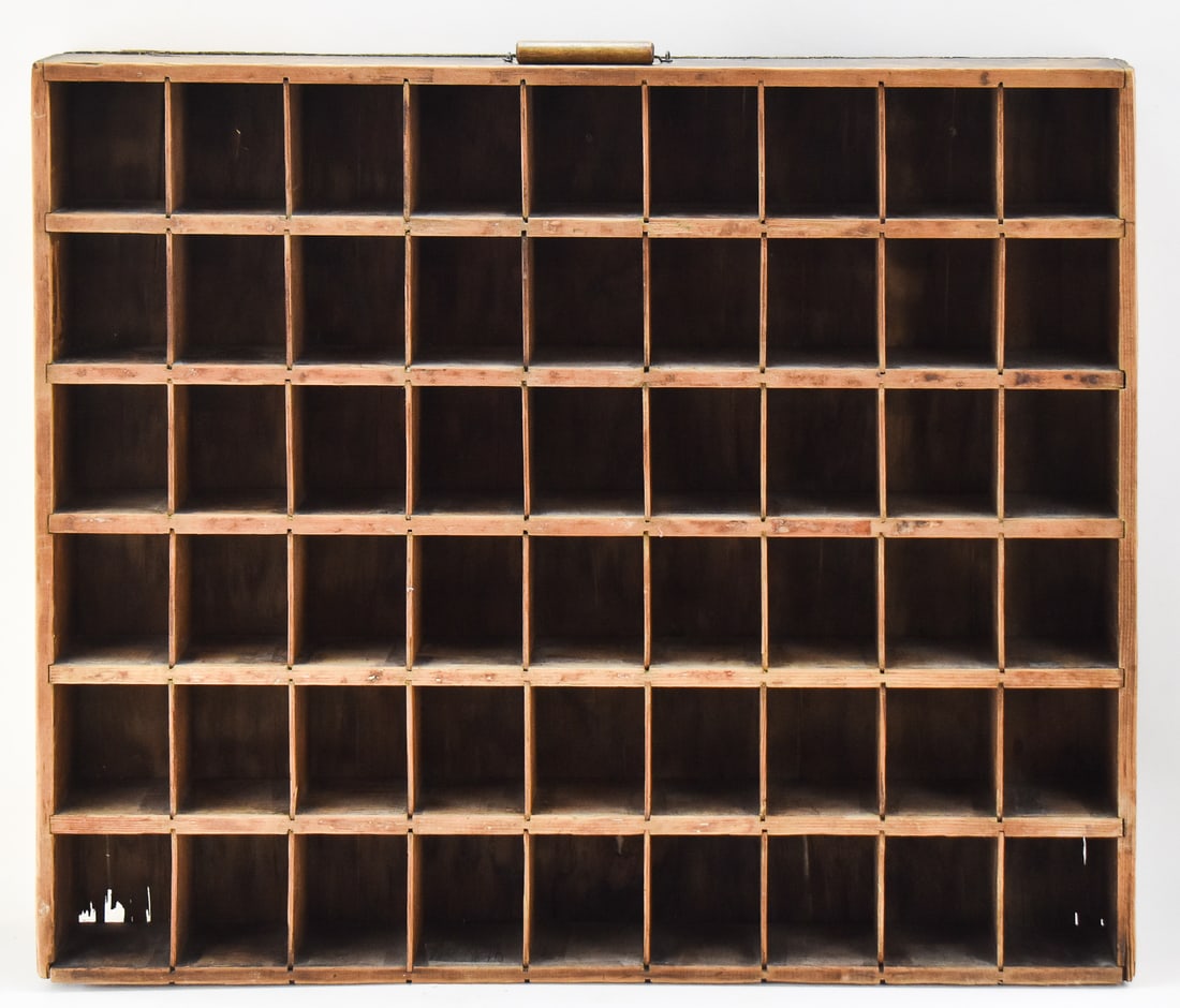 WOODEN DISPLAY SHELF: An early 20th century wooden display shelf with 54-compartments. The item measures approx. 29" H x 24.5" W x 4" D.