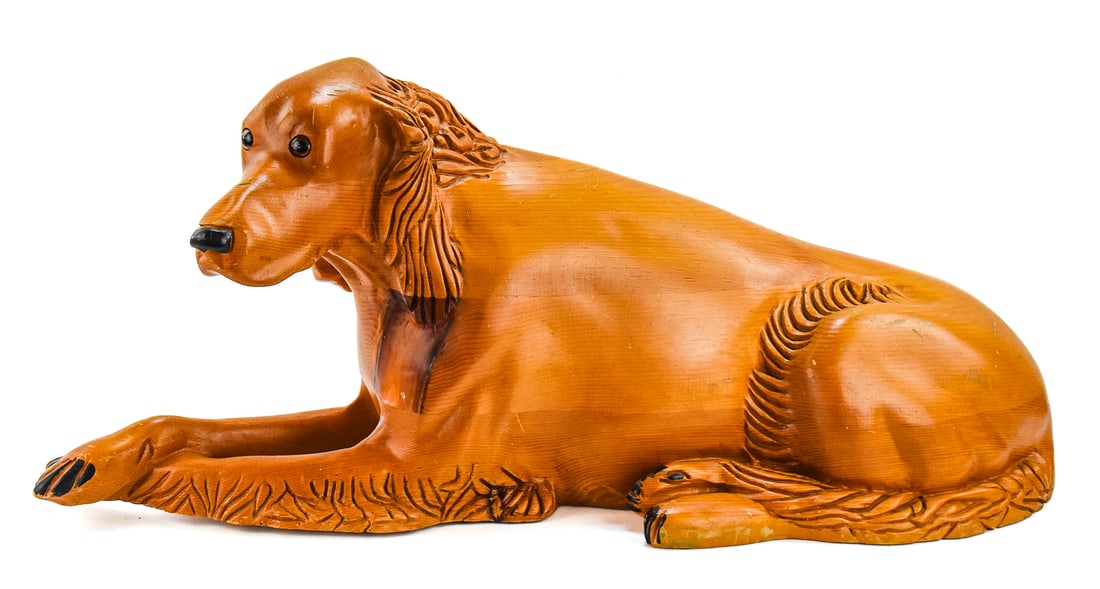 HAND-CARVED IRISH SETTER SCULPTURE: A hand-carved sculpture of a resting Irish Setter, circa 1960s. The item measures approximately 14" H x 35" W x 11" D.