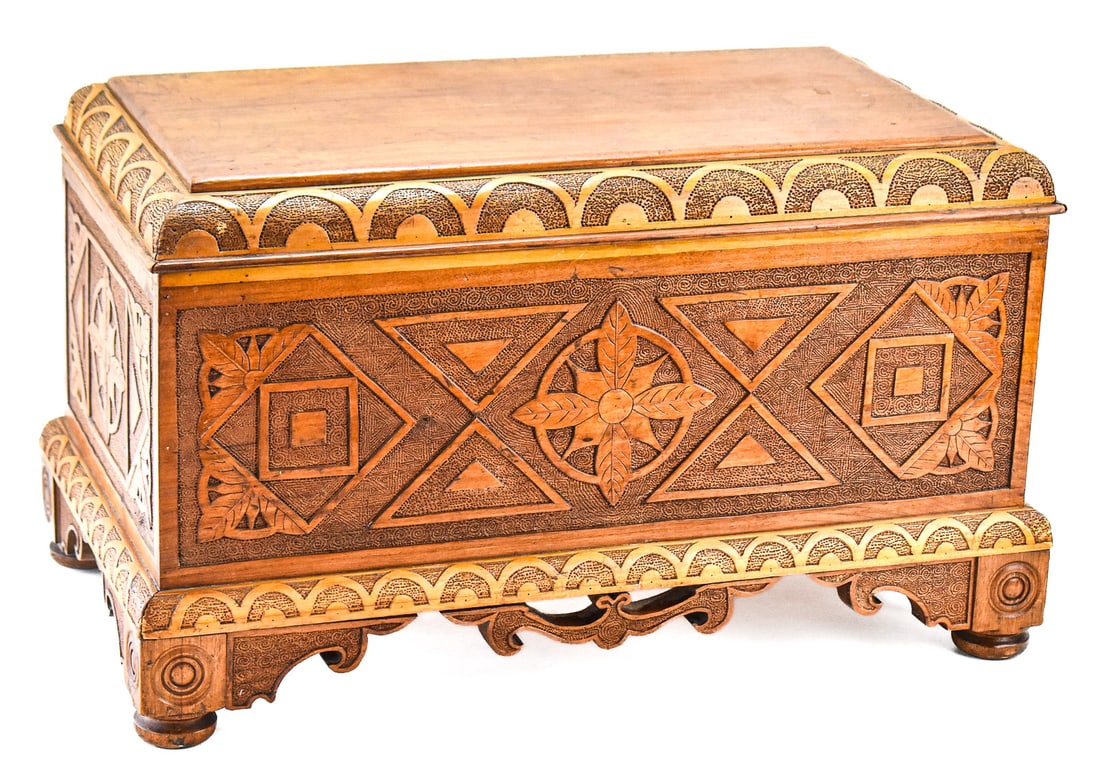 1934 FLORAL RELIEF-CARVED OAK CHEST: A 1934 floral relief-carved oak chest, dated underneath the lid; likely of European origin. The item measures approx. 13.5" H x 22.5" W x 13.5" D.