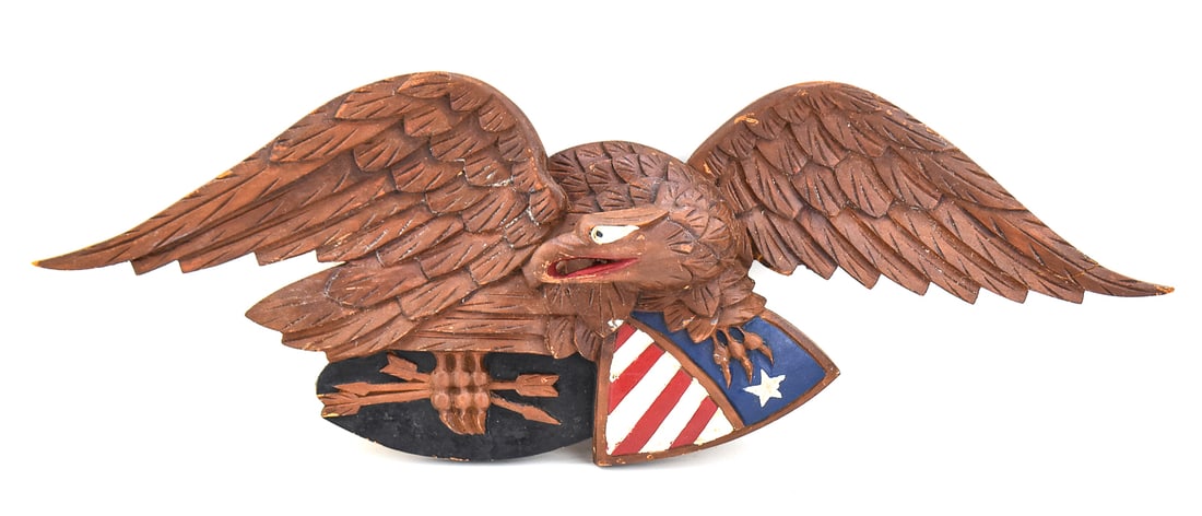 BELLAMY-STYLE LOUISBURG MODEL EAGLE CARVING: A polychrome carved Bellamy-style Louisburg model wall-hanging pine eagle, from the mid-20th century. The item measures approx. 10" H x 26" W x 3" D.
