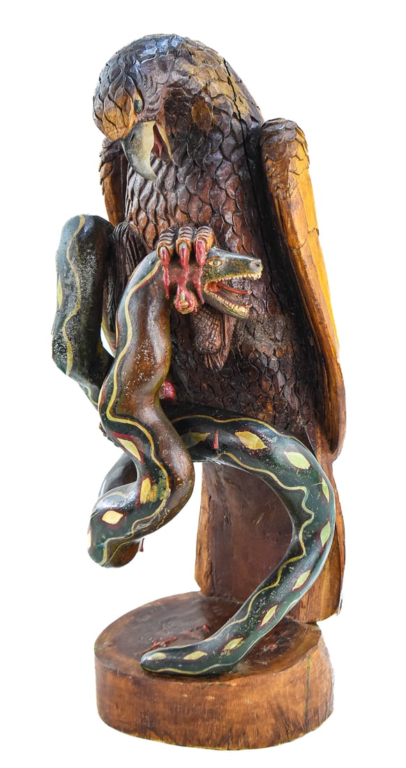 FOLK ART HAND-CARVED COPAL POLYCHROME EAGLE AND SERPENT SCULPTURE: A folk art hand-carved copal polychrome sculpture of an eagle grasping a serpent, from mid-late 20th century; likely Mexican or from the southern American states. The item measures approx. 24.5" H x 9