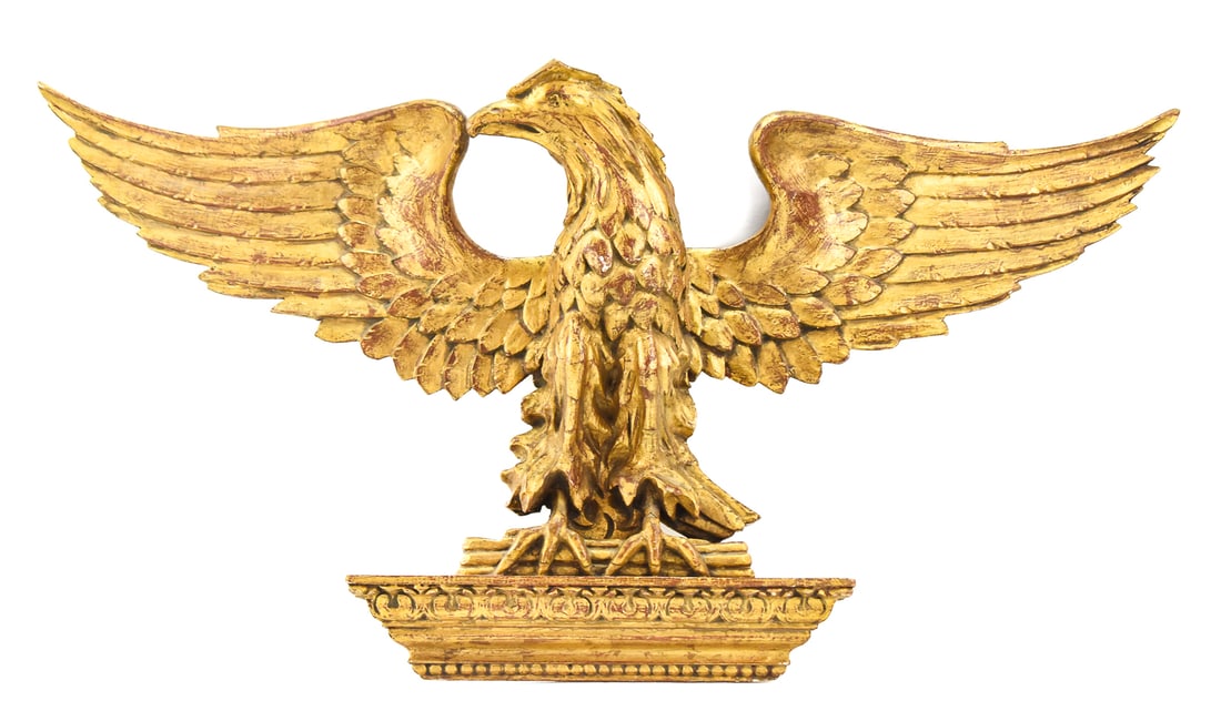 GEORGIAN-STYLE GILTWOOD MOUNTED EAGLE WALL ACCENT: A Georgian-style giltwood mounted eagle wall accent, from early 20th century. The item measures approx.18.5" H x 39.5" W x 7" D.