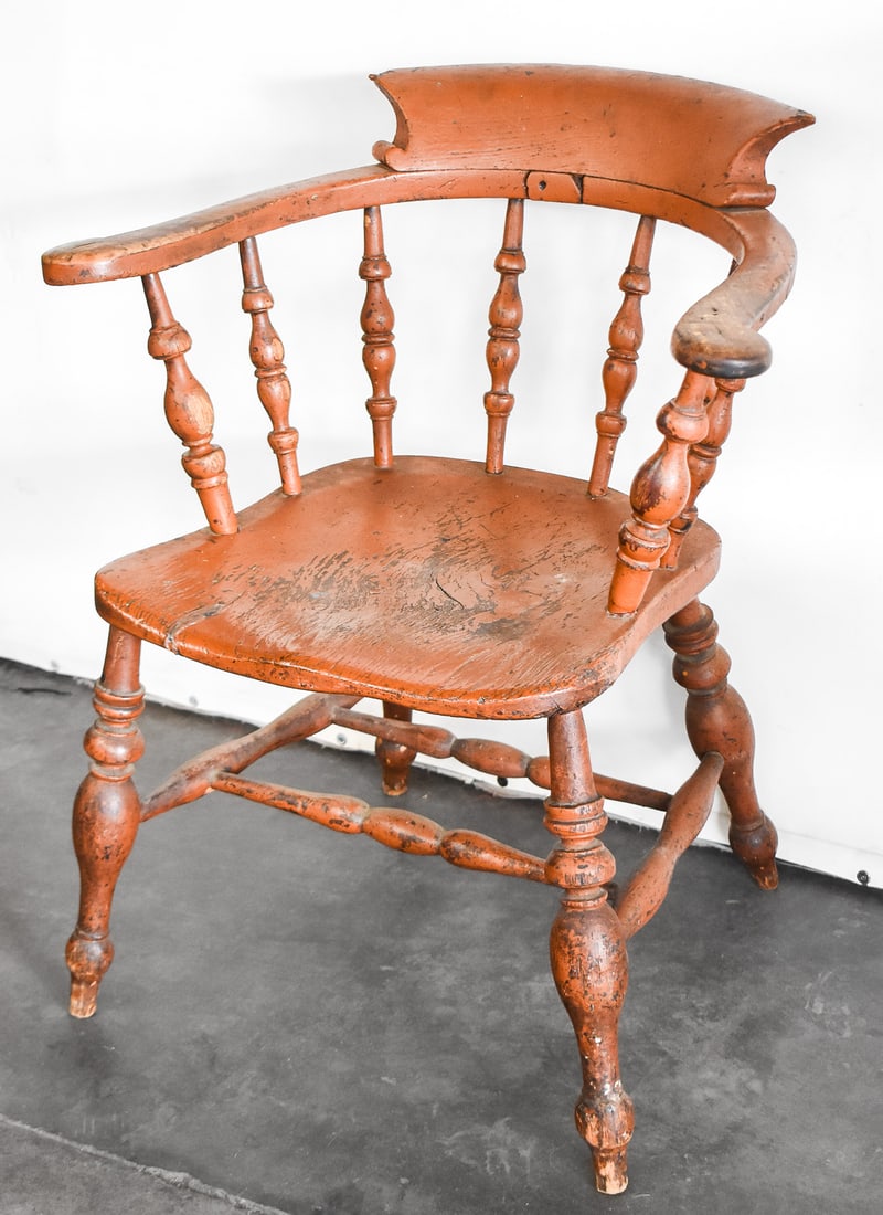 ENGLISH SMOKER'S BOW ARMCHAIR: This chair was crafted in the late 19th century of both elm wood and ash. The seat is made of elm and the more detailed pieces are ash. Chair measures approx. 30" H x 25.5" W x 19" D.