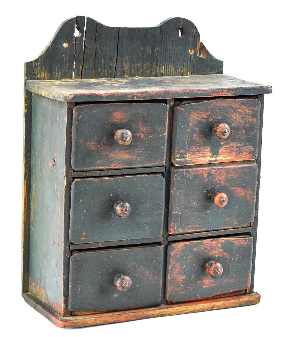 PRIMITIVE-STYLE BLACK-STAINED SPICE CABINET: A Primitive-style black-stained spice cabinet with six drawers from the late 19th century. The item measures approx. 12" H x 10" W x 4" D.
