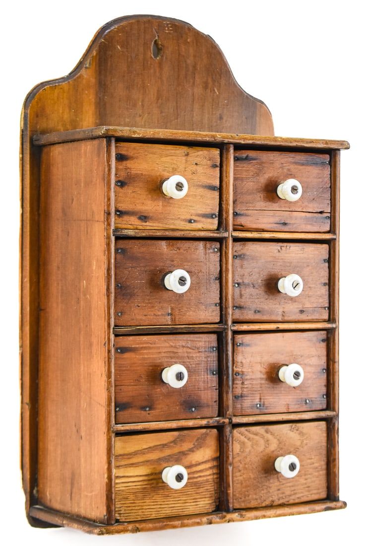 ANTIQUE SPICE CABINET: A late 19th-century spice cabinet with eight drawers and white porcelain knobs. The box measures approx. 17" H x 10" W x 5" D.