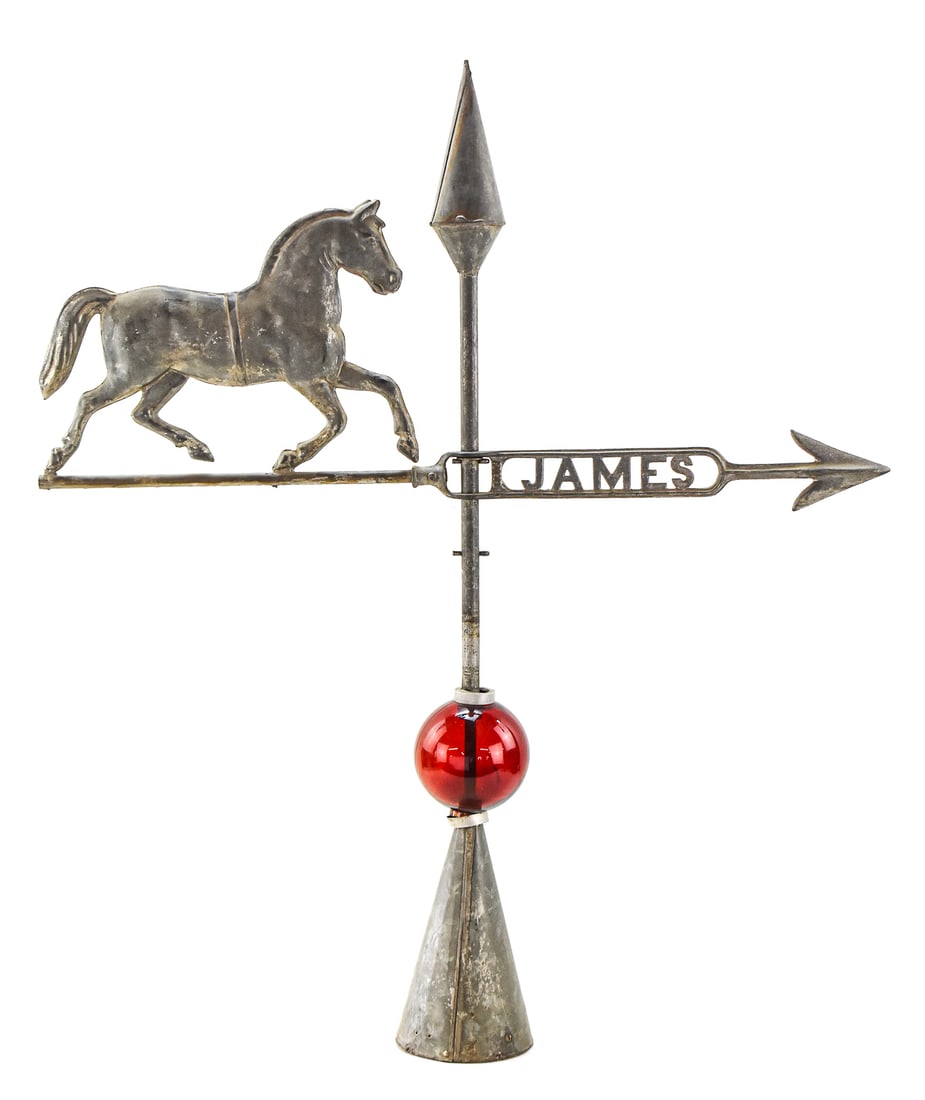 HORSE LIGHTNING ROD/ WEATHERVANE: This cast metal lightning rod and weathervane features a horse and the name James as well as a red glass lightning ball. It measures approx. 37.5" H x 32.5" W x 5" D.