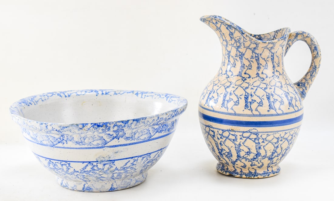BLUE SPONGEWARE WATER PITCHER AND BASIN SET: A blue spongeware water pitcher and basin set. The largest item measures approx. 5.5" H x 13" W x 13" D.