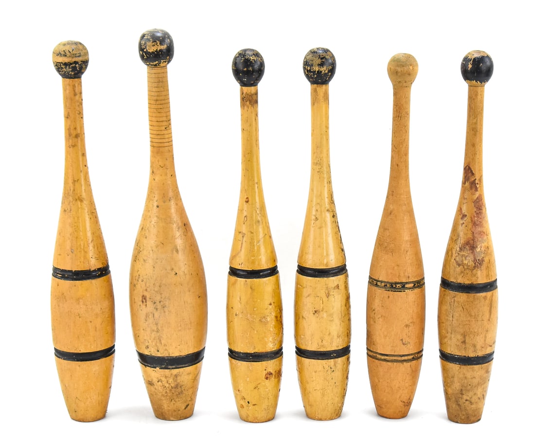 SET OF SIX WOODEN INDIAN CLUBS: A set of six turn-of-the-century wooden Indian Clubs or juggling pins. The largest measures approx. 17" H x 3.5" W x 3.5" D.