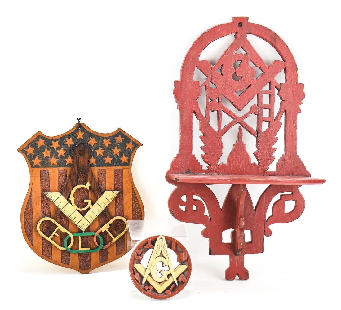 MASONIC WOOD CARVING WALL HANGERS: This lot consists of three masonic wood carvings from the early 20th century: a decorative hanging shelf with masonic imagery, masonic round wall plaque featuring the square and compass symbols and a