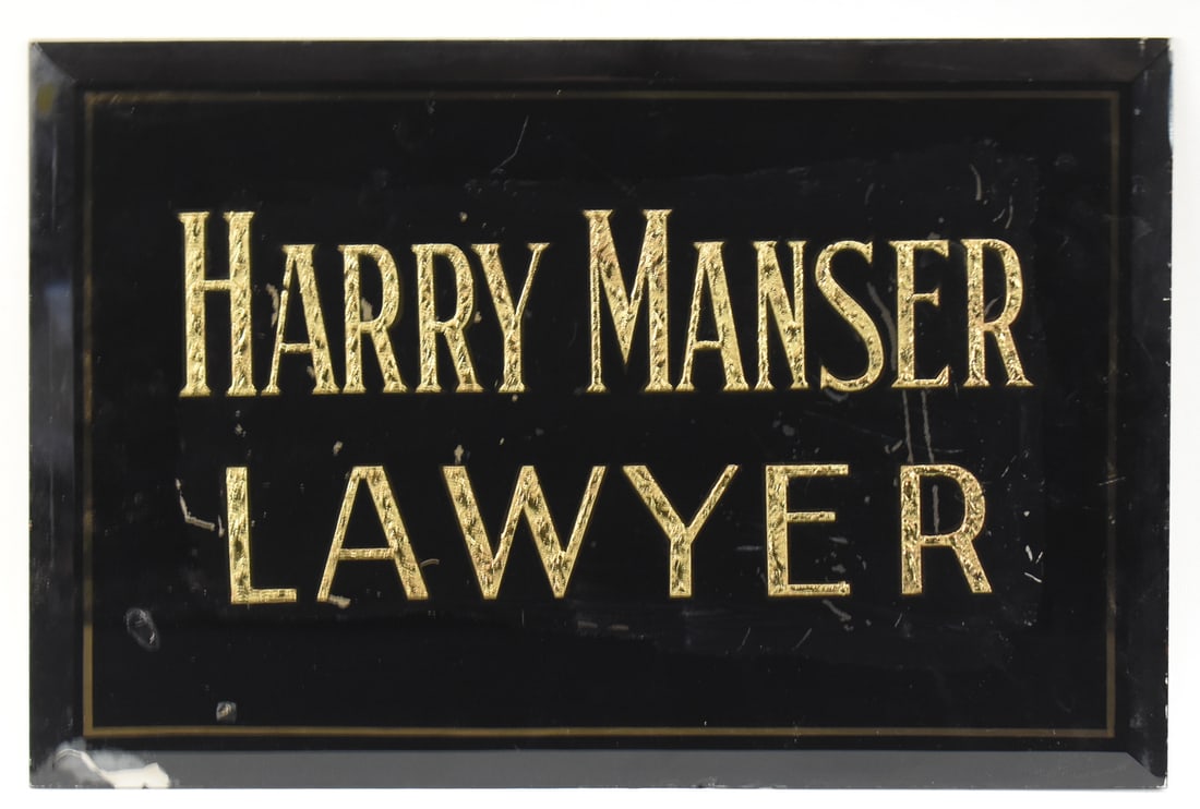 SIGN ADVERTISING THE LAWYER HARRY MANSER: A painted glass advertising sign for Lawyer Harry Manser, measuring approx. 10" H x 15" W x 0.5" D.