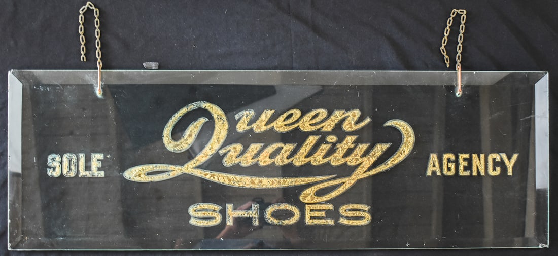 THOMAS G. PLANT COMPANY "QUEEN QUALITY SHOES" GLASS ADVERTISEMENT SIGN: A Thomas G. Plant Company (Boston, MA) "Queen Quality Shoes" glass advertisement sign with gilt lettering, circa late 19th century. The item measures 12" H x 36" W x 0.5" D.