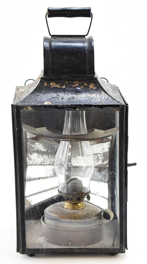 SHEET IRON UTILITY LANTERN W/ PLUME & ATWOOD OIL LAMP: A Plume & Atwood Manufacturing Company coated sheet iron utility lantern with a segmented mercury glass reflector and an oil lamp burner, from late 19th century. The lantern measures approx. 20" H
