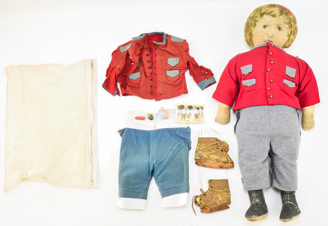ART FABRIC MILLS CLOTH DOLL; C. EARLY 1900s: A marked Art Fabric Mills (NY) cloth doll with an extra set of clothes, accessories, and a photograph of likely a previous owner with the doll, patented 1900. The doll measures approx. 25" H x 11" W