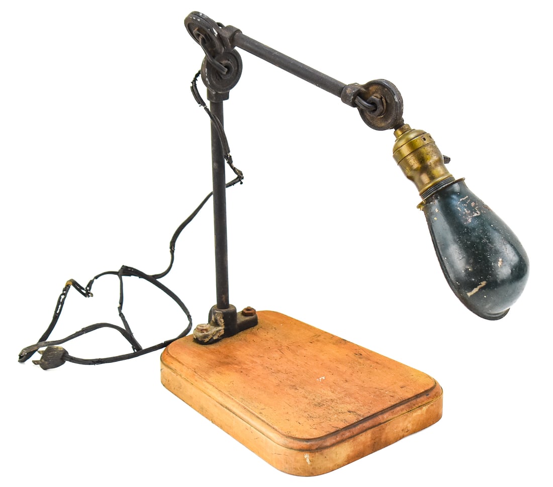 CHICAGO DIE CASTING MANUFACTURING COMPANY INDUSTRIAL TASK LAMP: A Chicago Die Casting Manufacturing Company industrial task lamp on a wooden base, circa 1940s-1950s. The die-cast connection joints have the company's makers mark. The item measures approx. 14" H x