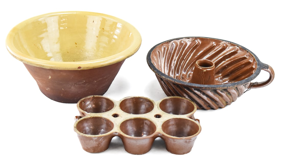 STONEWARE KITCHENWARE: PANCHEON BOWL, BUNDT CAKE MOLD, AND MORE: An assortment of stoneware kitchenware from the early 20th century including: a six cup baking dish, Bundt cake mold, and a Pancheon bowl. The Pancheon bowl measures approx. 6" H x 13" W x 13" D.