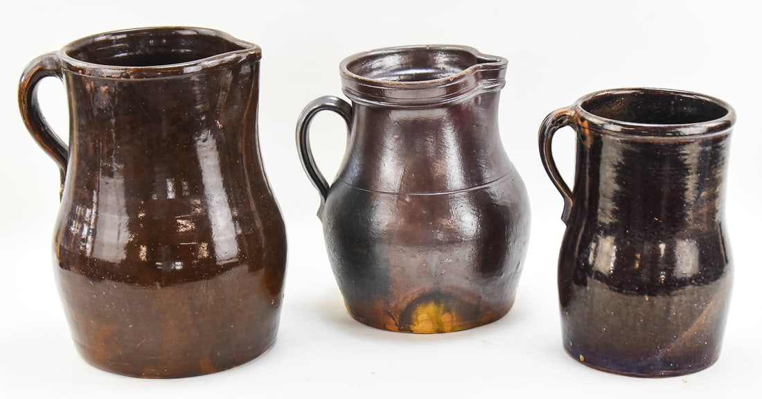 TRIO OF DARK BROWN STONEWARE PITCHERS (1 of 4)