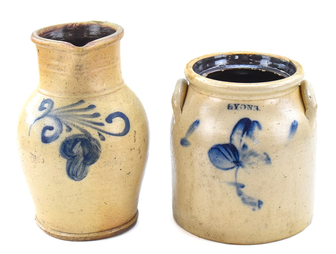 TWO NEW YORK STYLE STONEWARE PITCHERS: This lot includes two New York style stoneware pitchers, from the late 19th century; one is from Lyons, NY. The largest item measures approx. 11.5" H x 7" W x 7" D.