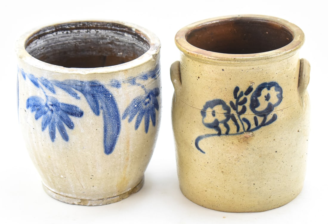 TWO PENNSYLVANIAN STYLE STONEWARE CROCKS: This lot includes two Pennsylvanian style stoneware crocks featuring cobalt blue floral motifs, from the late 19th century. The largest item measures approx. 11.5" H x 7" W x 7" D.