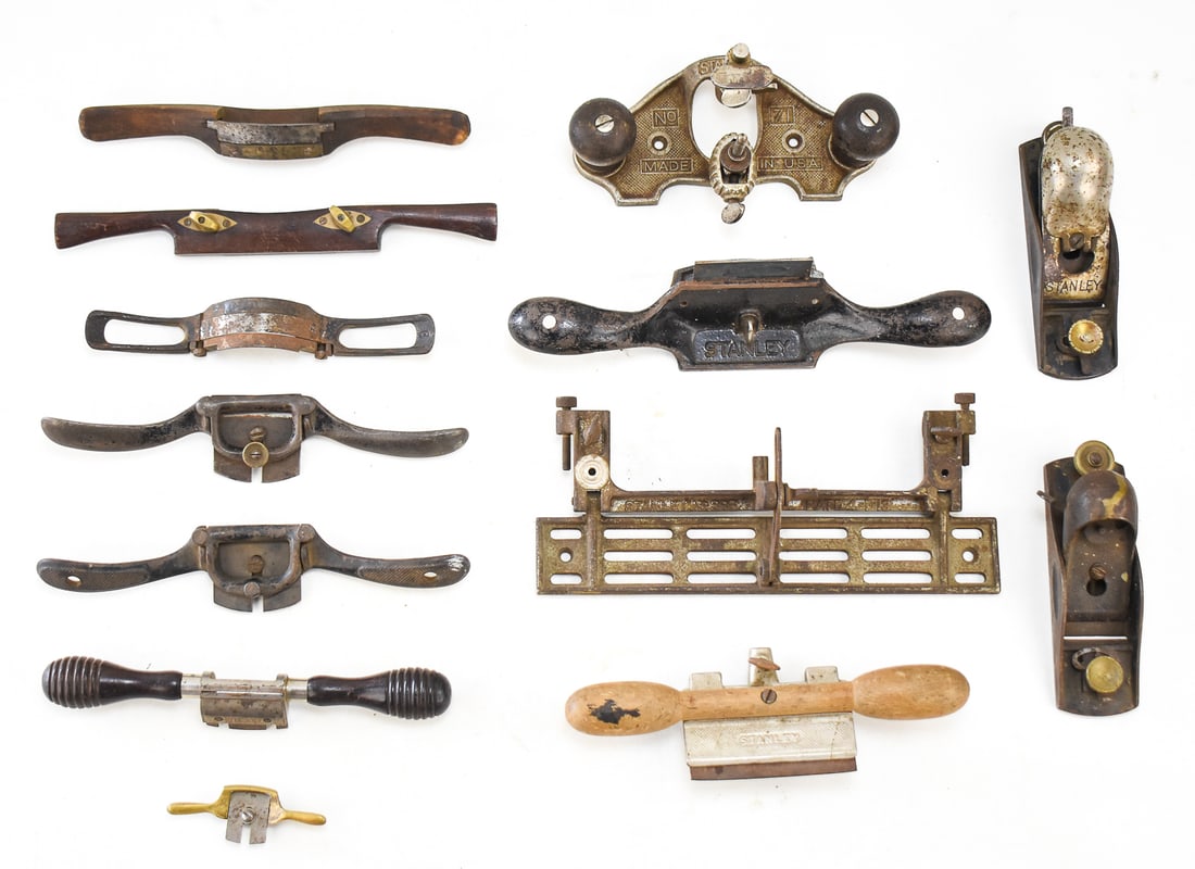 COLLECTION OF SCRAPERS, PLOW SHAVES, SPOKE SHAVES, PLANES: STANLEY, SNELL & ATHERTON: A collection of antique tools including a Stanley No. 71 router plane, a Stanley No. 83 scraper, A Stanley No. 80 cabinet scraper, a Stanley sweetheart No. 53 spoke shave, a Stanley No. 67 spoke shave