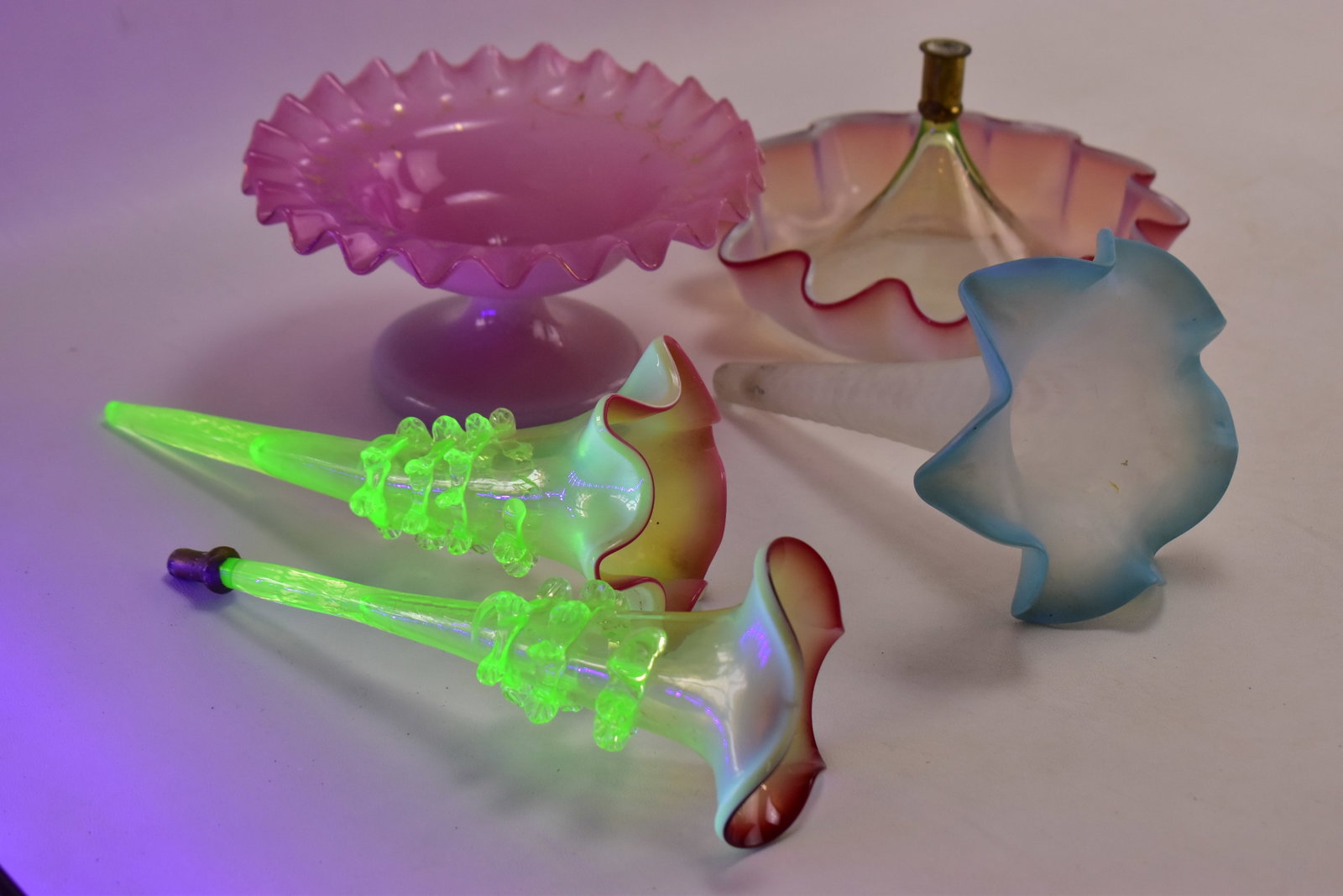 VICTORIAN ART GLASS EPERGNE BASES AND TRUMPET VASES: This lot includes the following: Victorian art glass epergne base and trumpet vase in a cranberry opalescent rim and uranium glass, uranium glass trumpet vase with a pink opalescent rim, Fenton Art Gl