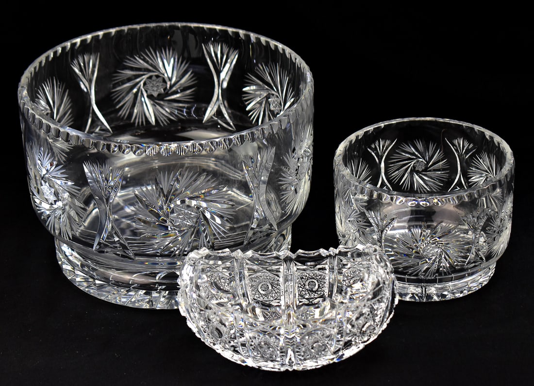 THREE AMERICAN BRILLIANT PERIOD CUT-CRYSTAL BOWLS: Three American Brilliant Period cut-crystal bowls including a matching smaller and larger bowl with 'Pinwheel and Starburst' patterns, and an oval shaped cut-crystal bowl with hobstar pattern and a sa