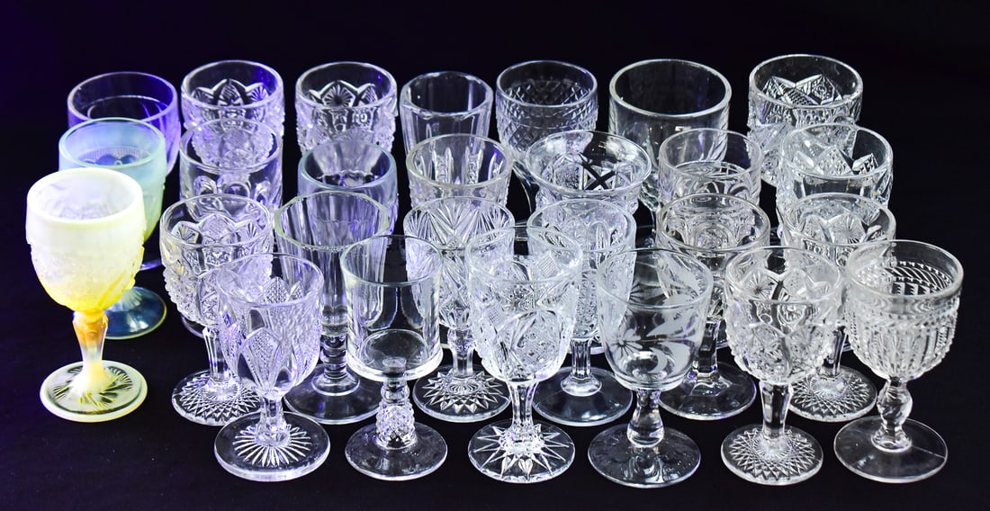 COLLECTION OF WINE/CORDIAL GOBLETS: CADMIUM GLASS, WESTMORELAND, IMPERIAL, EAPG: A collection of 28 small wine/cordial goblets from a variety of makers including Westmoreland, Imperial Glass, Libbey, McKee Brothers; and a cadmium glass goblet, and a variety of other Early