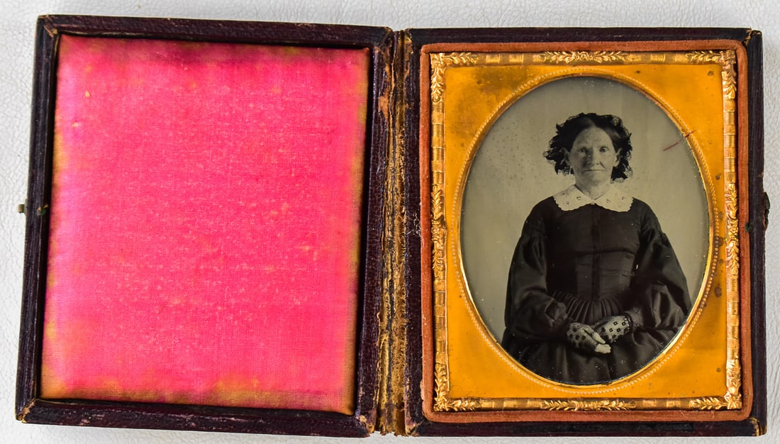 WILLIAM SHEW AMBROTYPE OF A WOMAN IN BLACK: A William Shew (Boston, MA) 1/6th plate wooden and leather case in a floral pattern containing an ambrotype of an older woman likely in mourning, circa 1840s. William Shew (1820–1903) was a
