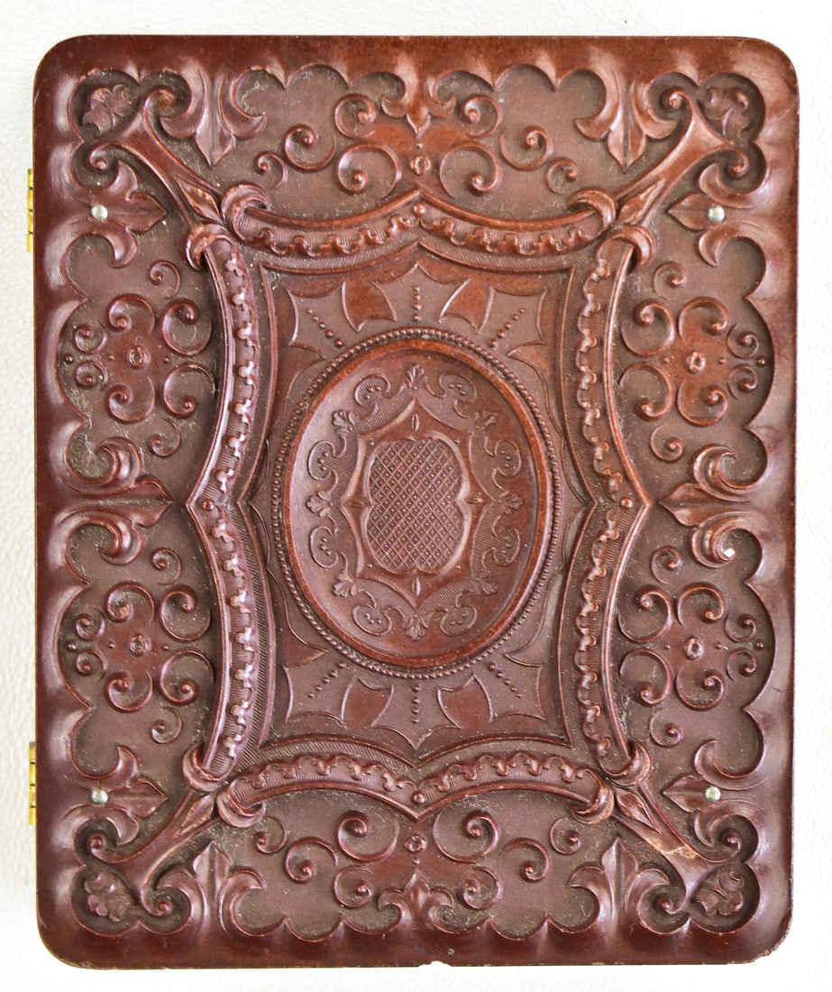 SCOVELL MANUFACTURING COMPANY AMBROTYPE CASE: A Scovell Manufacturing Company (Waterbury, CT) 1/4th plate ambrotype case No. 208 featuring a floral design along with a round depression for a circular photo, circa 1861. Case measures approximately