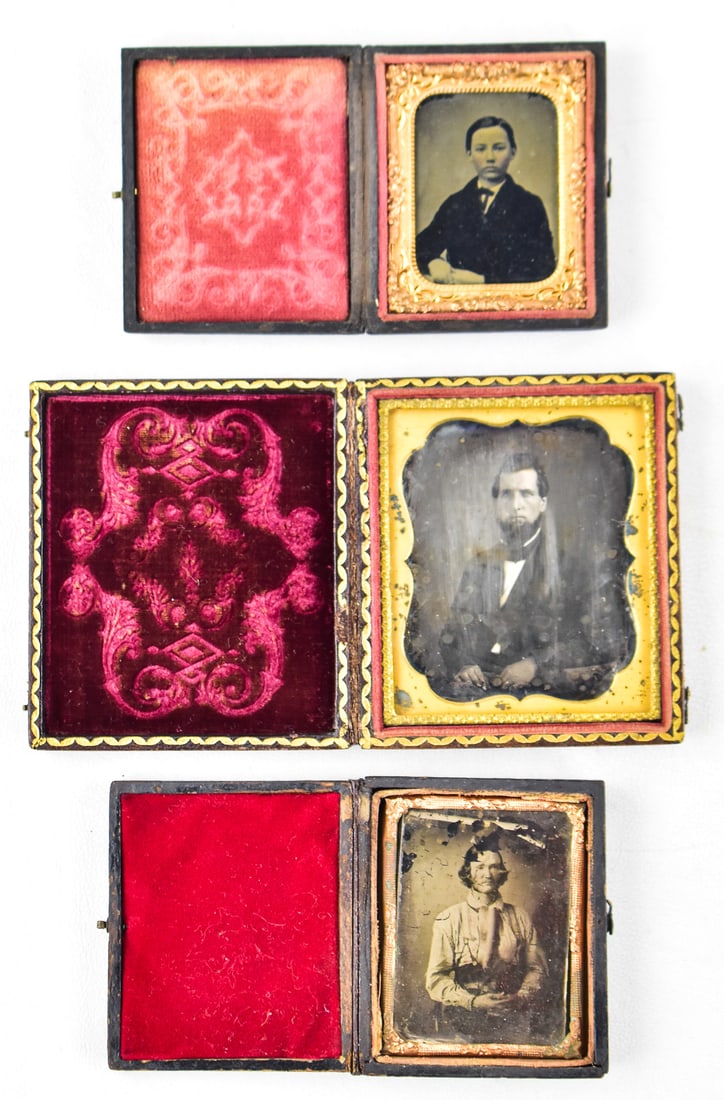 TRIO OF MALE AMBROTYPES: This lot includes three ambrotypes of men, circa 1850s: young boy in a 1/9th plate plastic daguerreotype case, seated man ambrotype in a 1/9th plate leather case, and a seated bearded man in a 1/9th