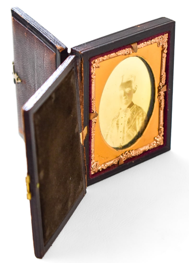 DOUBLE-SIDED CASED AMBROTYPE PHOTOGRAPH, CIRCA 1850s: A double-sided cased ambrotype produced by Mathew B. Brady, circa 1850s. The dark backing of the case allows the viewer to view the photograph on glass from each side of the case. This cased