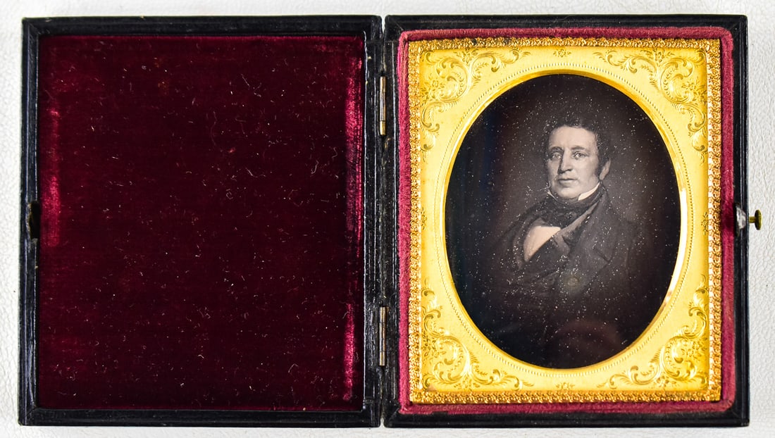 DAGUERREOTYPE PAINTING: This daguerreotype is a painting of a clean shaven man in a 1/6 plate leather case with a red lining. When closed it measures approximately 4" H x 3" W x 0.5" D.