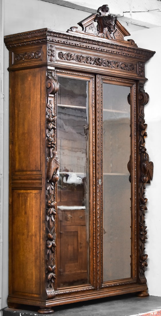 FRENCH RENAISSANCE REVIVAL CARVED OAK DISPLAY CASE: This cabinet is hand carved from oak wood circa late 19th century. The cabinet has a "hunt style" motif in the carving themed around wildlife. Cabinet measures approximately 95" H x 49.5" W x 18.5" D.