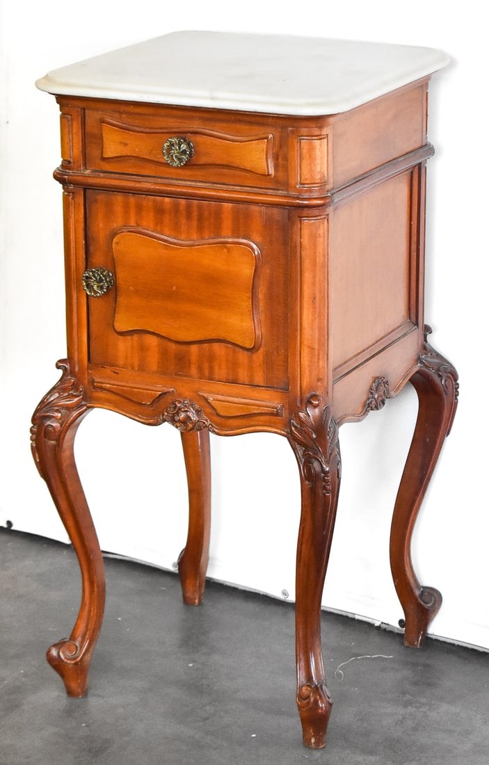 FRENCH LOUIS XV REVIVAL STYLE BEDSIDE CABINET: A French Louis XV Revival style walnut bedside cabinet with a marble top, circa 1890-1910s. The cabinet approximately measures 34" H x 17" W x 17" D.
