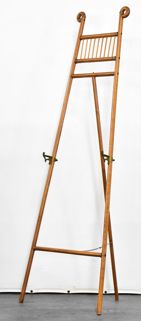 STICK AND BALL STYLE FLOOR DISPLAY EASEL: This easel was crafted of oak wood circa 1900s. It measures approx. 61" H x 18.5" W x 13" D.