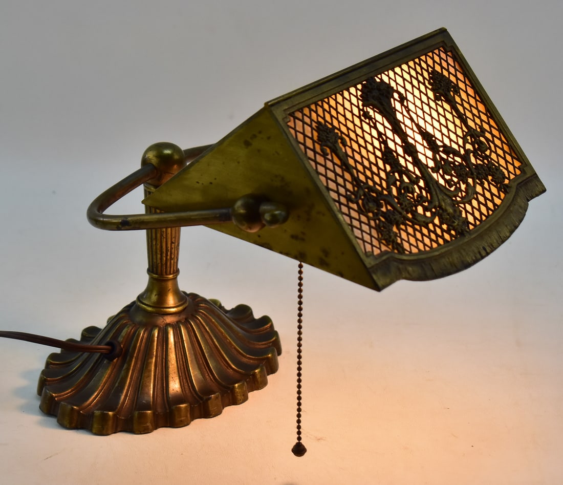 BRADLEY & BBARD SLAG GLASS BANKER'S DESK LAMP: This lamp was manufactured by Bradley & Hubbard Mfg. Co. in Meriden, Connecticut circa 1920s. The lamp is made of cast metal, slag glass panels and decorative bronze filigree. Lamp measures