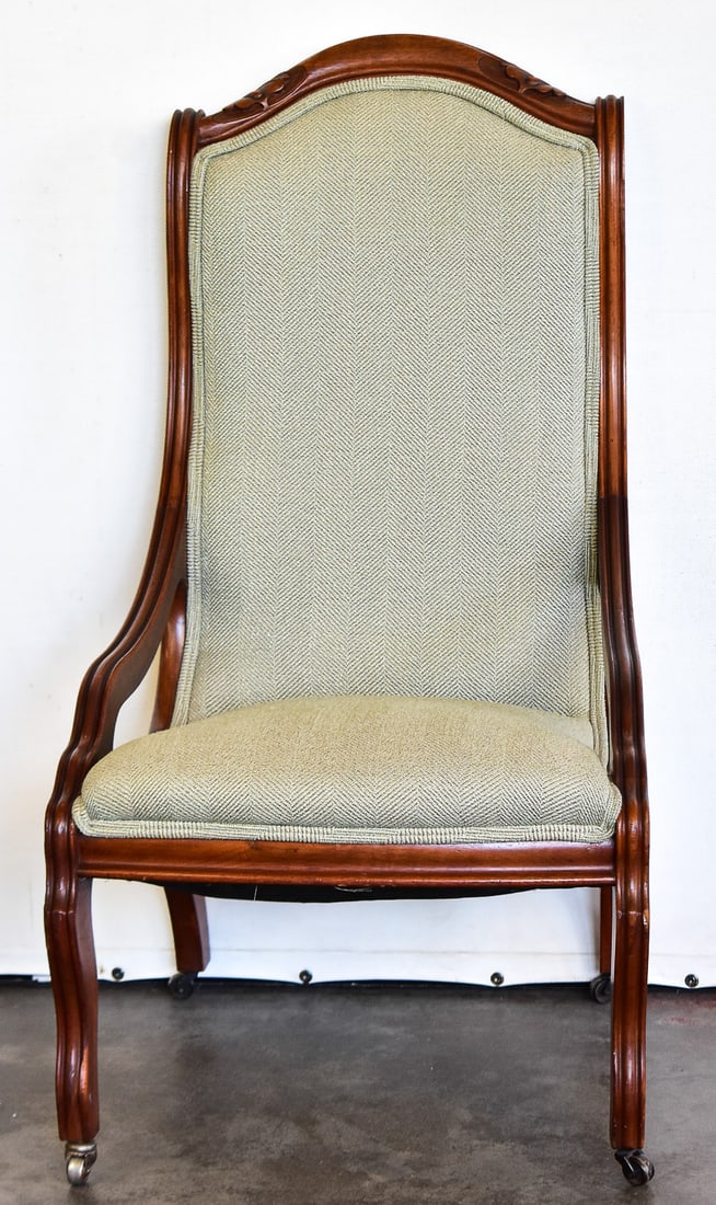 CARVED WALNUT PARLOR CHAIR: This chair was hand carved from walnut wood and has castors attached to the bottom on the legs. Fabric is a modern day linen herringbone. Chair measures approx. 39" H x 21" W x 21" D.