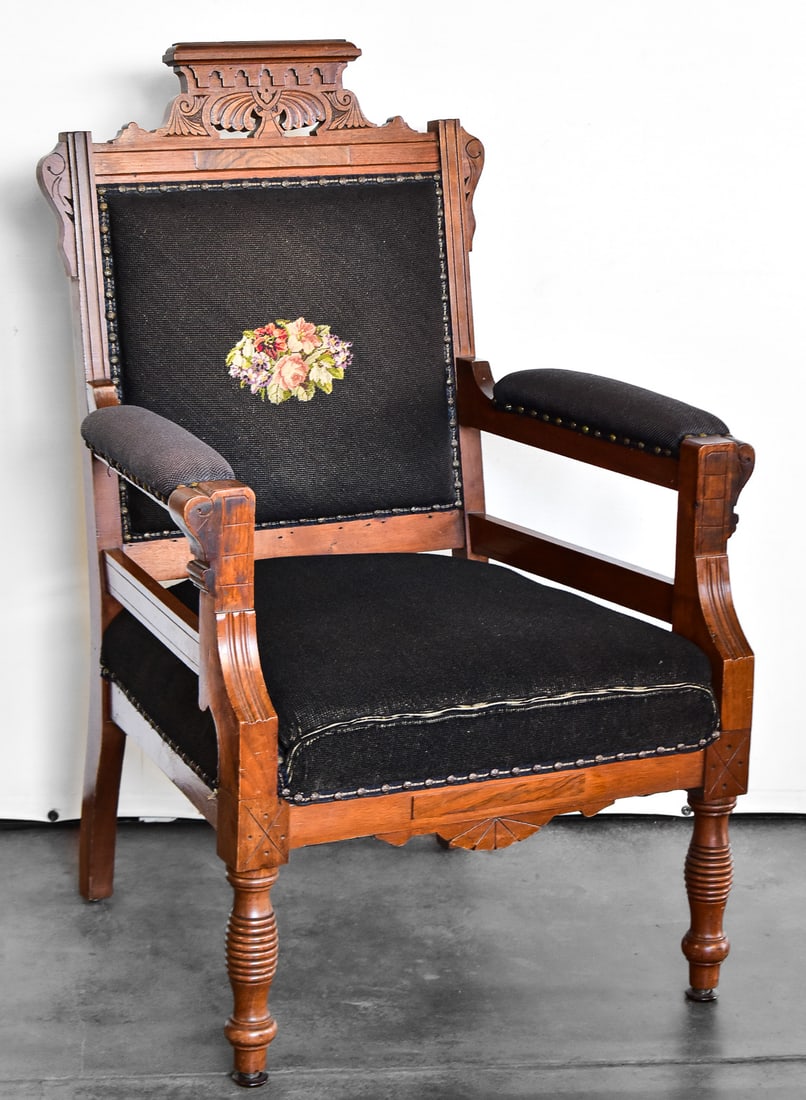 AMERICAN EASTLAKE STYLE PARLOR ARMCHAIR: An American Eastlake style walnut parlor armchair with floral upholstery, turn of the 19th century. Chair measures approximately 39" H x 24.5" W x 23" D.