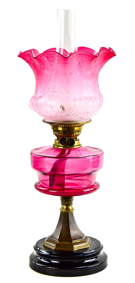 CRANBERRY GLASS OIL LAMP: This lamp still has its original oil lamp parts and still burns oil. The top shade has a satin etched floral pattern and a ruffle rim, along with a glass chimney. The two knobs on the sides read