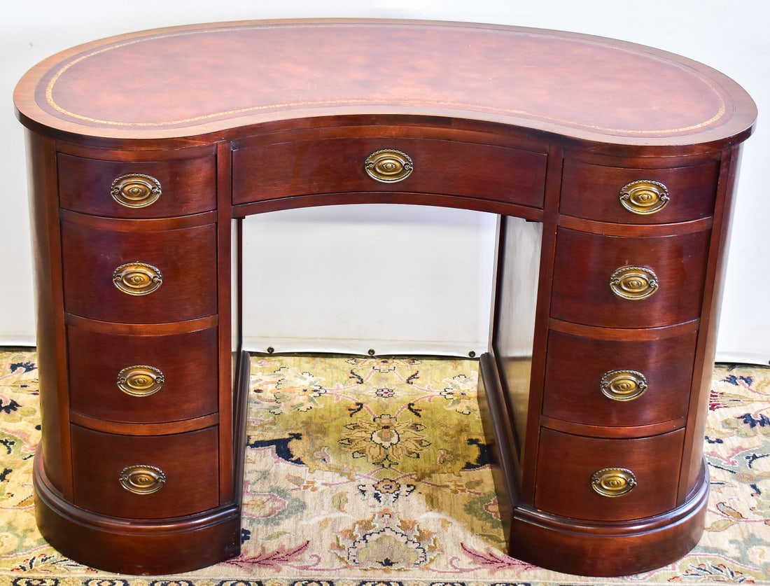 MADDOX LEATHER TOP KIDNEY DESK: This desk is made of mahogany wood with brass pulls and manufactured by Maddox Table Company in Jamestown, New York circa mid 20th century. Table measures approximately 30" H x 45" W x 23" D.