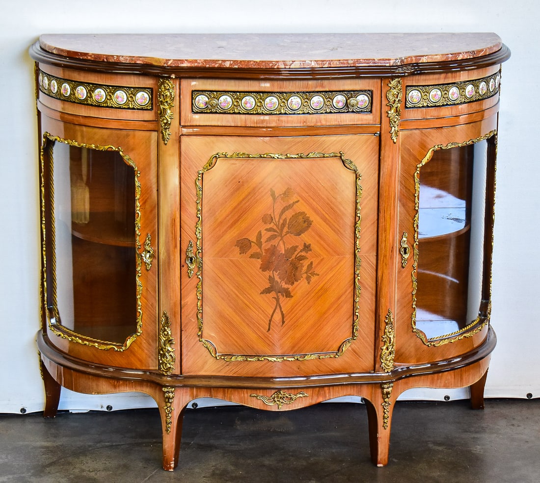 LOUIS XV STYLE HALF MOON DEMILUME CURIO CABNIET: This style resurged in the 1960s-1980s. It mimics the French Rococo design elements like the demilune silhouette, cabriole legs, floral marquetry inlays, marble top and gilt brass hardware. There an
