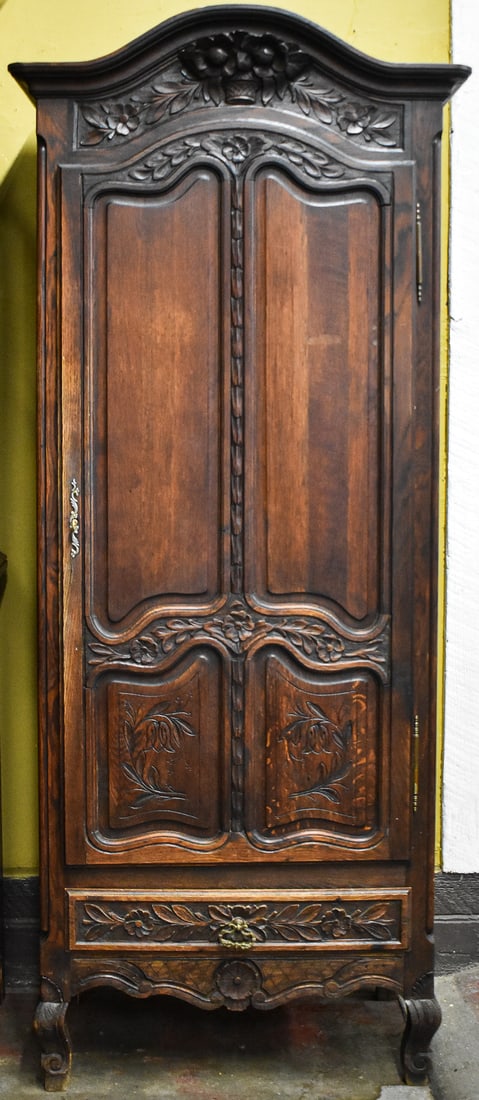 PROVICIAL STYLE BONNETIERE(SINGLE DOOR AMOIRE): This armoire is made of oak then overlayed with a dark stain. This armoire only has a single door and has asymmetrical panel molding. It has a single drawer below. The unit measures 81" H x 29.5" W x