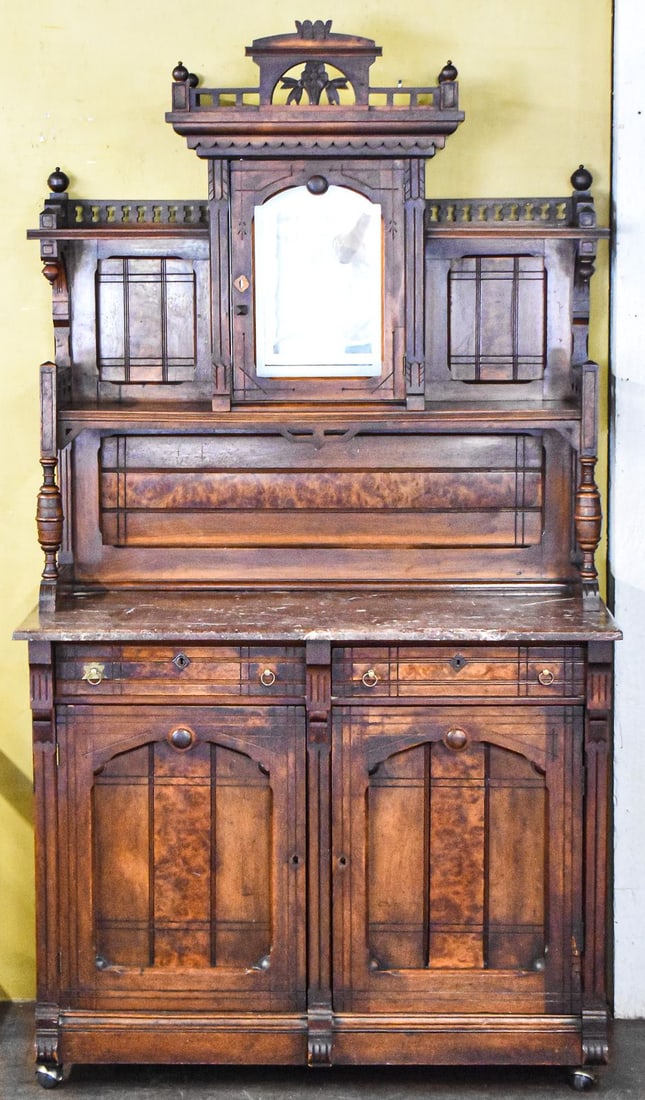 LATE VICTORIAN EASTLAKE MARBLE TOP SIDEBOARD: A late Victorian Eastlake style marble top sideboard with walnut burl veneer panels, multi-tier hutch with spindle galleries, and a central mirror display cabinet; late 19th century. The sideboard