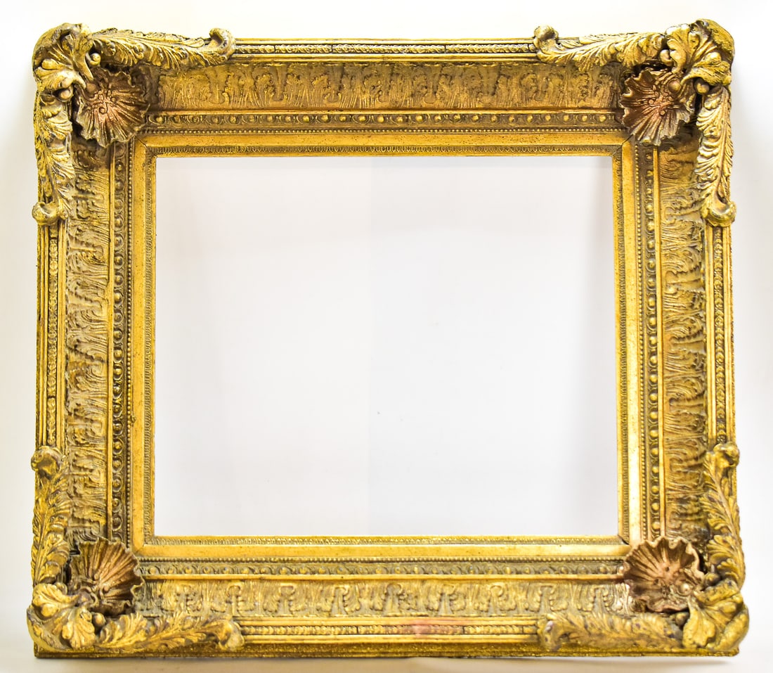 ORNATE GILT FRAME: This frame has a wood base layered with plaster molding. It is then covered in gold leaf gilding. The frame measures approximately 32" H x 35" W x 6.5" D, with the inner hole measures approximately