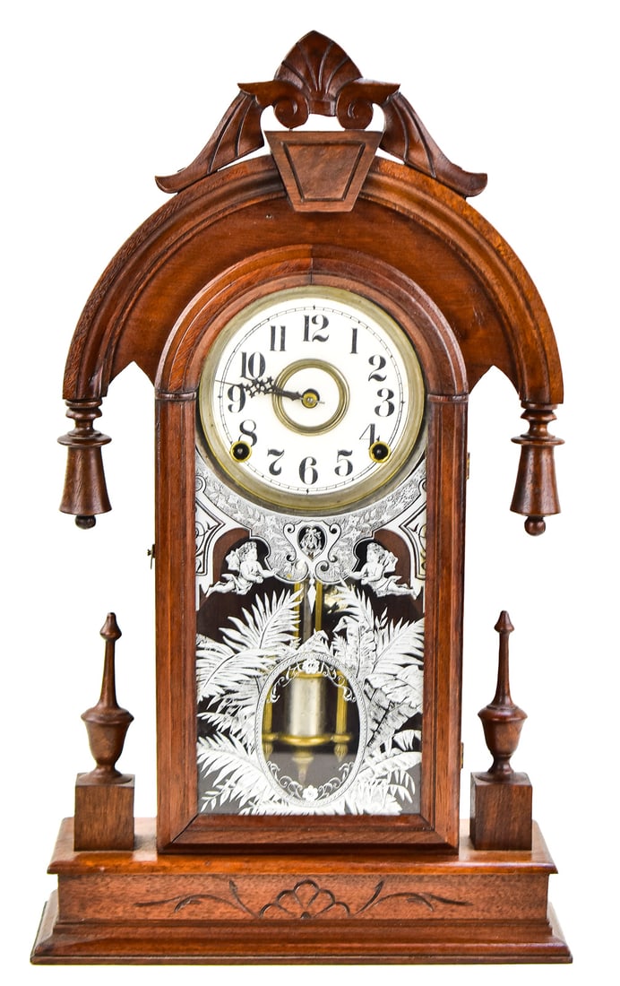 NEW HAVEN "ELBE" 8-DAY SHELF CLOCK: A New Haven Clock Company "Elbe" 8-day time and strike movement shelf clock with a walnut case, circa 1884. The clock measures approx. 21" H x 12" W x 5" D.