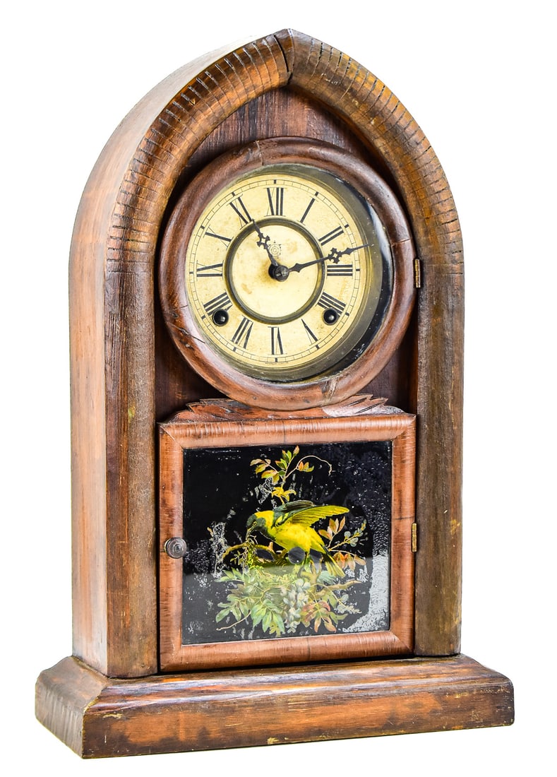 BEEHIVE MANTEL SHELF CLOCK, WATERBURY CLOCK COMPANY: A beehive 8-day time and strike mantel shelf clock made by the Waterbury Clock Company of Waterbury, Connecticut, made in the late 19th/ early 20th century. The clock has an arched wood case, reverse