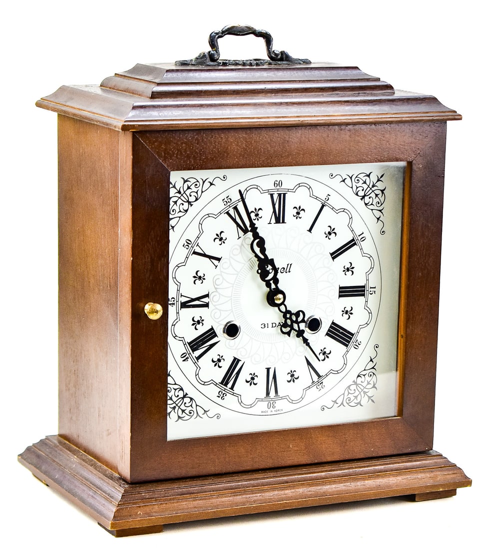RONELL 31-DAY MECHANICAL MANTEL CLOCK: A Ronell 31-day mechanical key-wind mantel clock, made in Korea in the mid-20th century. The clock has a Roman numeral dial The clock measures approximately 14" H x 12" W x 8" D.