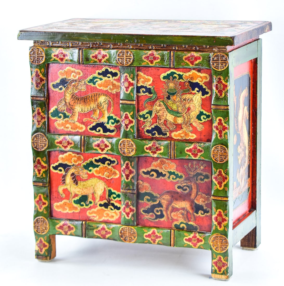 HAND-PAINTED TIBETAN CABINET, EARLY 20TH CENTURY: A hand-painted Tibetan small cabinet painted with polychrome mineral paints in traditional Himalayan designs, made in the early 20th century. The cabinet has a top and bottom storage section, with