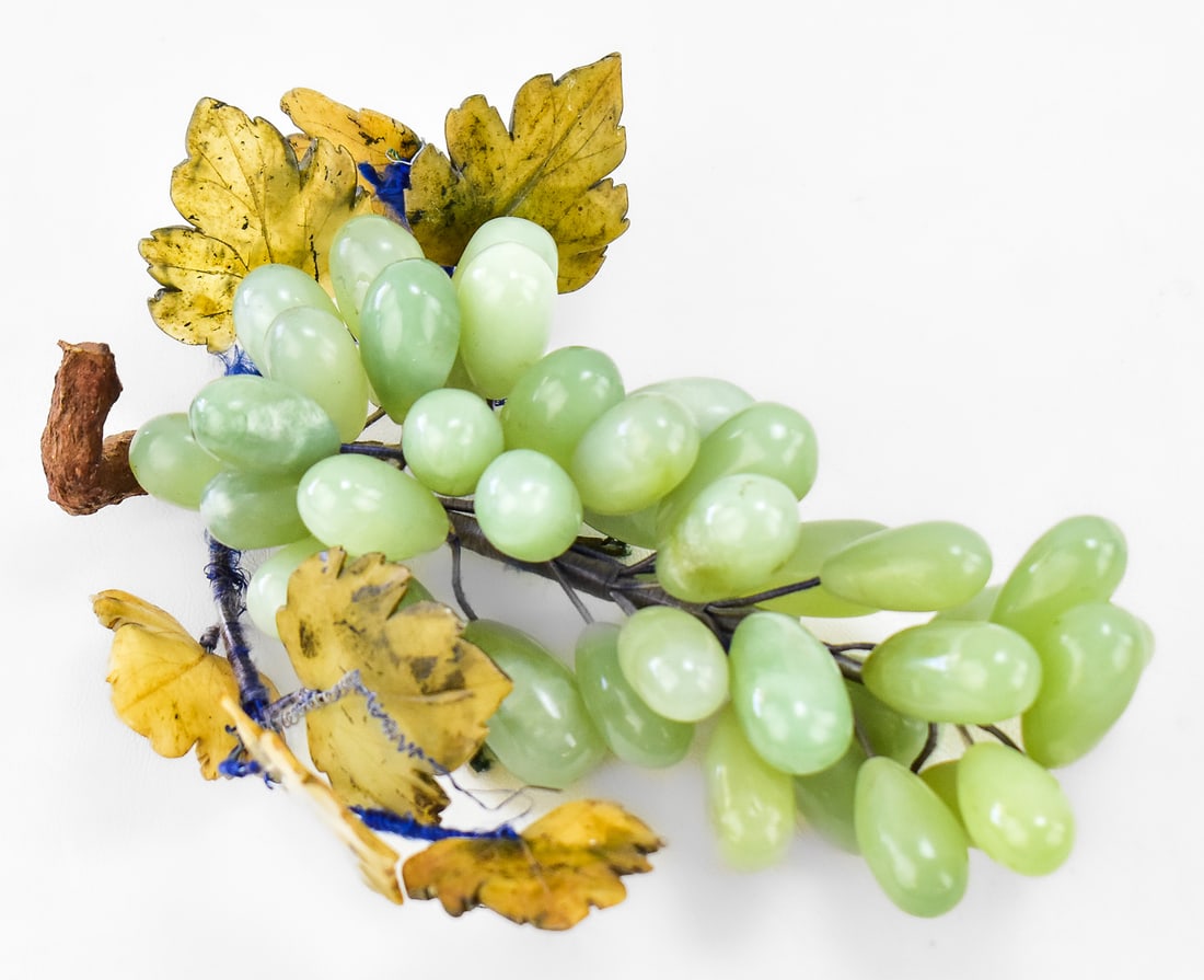 ASIAN CARVED JADE GRAPE CLUSTERS: An Asian decorative stone grape cluster with grapes carved out of nephrite jade and leaves carved out of agate. The grape cluster measures approx. 9" H x 8" W x 3.5" D.