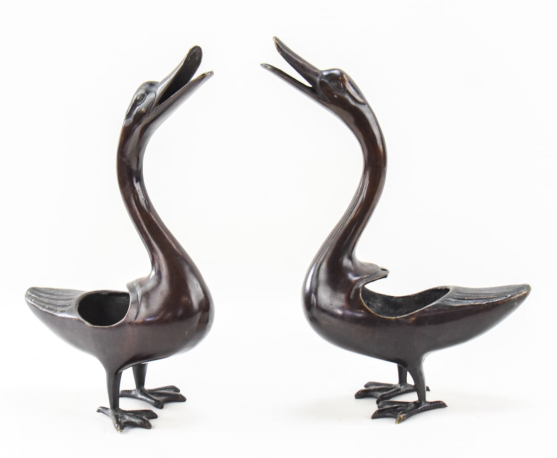CHINESE BRONZE GEESE INCENSE HOLDERS, CIRCA EARLY 20TH CENTURY: A pair of Chinese bronze geese incense holders from the Republic Period, circa early 20th century. Each goose is marked on the bottom "Chisan" in Chinese. The geese measure approximately 13.5" H x 3.5